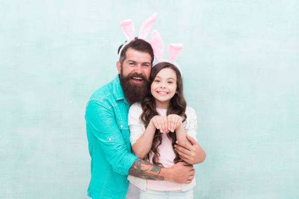istock Better together. Spring holiday. Easter activities for family. Happy easter. Holiday bunny long ears. Family tradition concept. Dad and daughter bunny ears. Father and child celebrate easter 1372104937