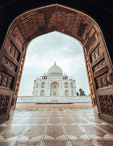 Agra, India - 09.11.2022 - Taj Mahal white marble mausoleum landmark in Agra, Uttar Pradesh, India, beautiful ancient tomb building of Mughal architecture, popular touristic place marble exterior