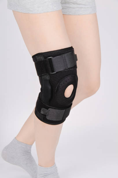 istock Knee Support Brace on leg isolated on white background. Elastic orthopedic orthosis. Anatomic braces for knee fixation, injuries and pain. Protective knee joint bandage sleeve. Trauma, rehabilitation 1372106080
