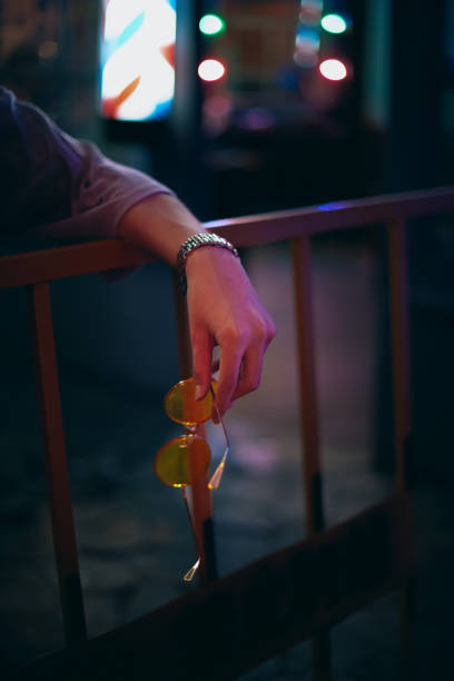 A hand with eyes in the dark at night