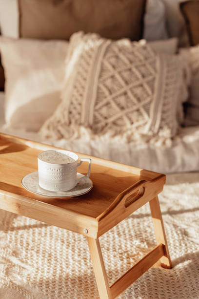 istock wooden table with a cup Empty Bed, Elegant Brick Wall on Background. Bedroom Modern and Cozy Interior. Soft Pillow and Blanket, Stylish Comfortable Furniture 1372106384