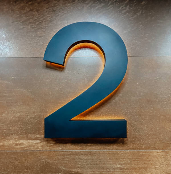 istock Metal Number two 2 on a wooden wall 1372106394