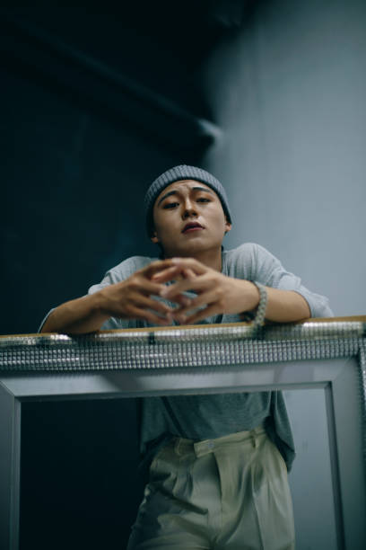 istock Asian handsome young men leaning on the shelf 1372106969