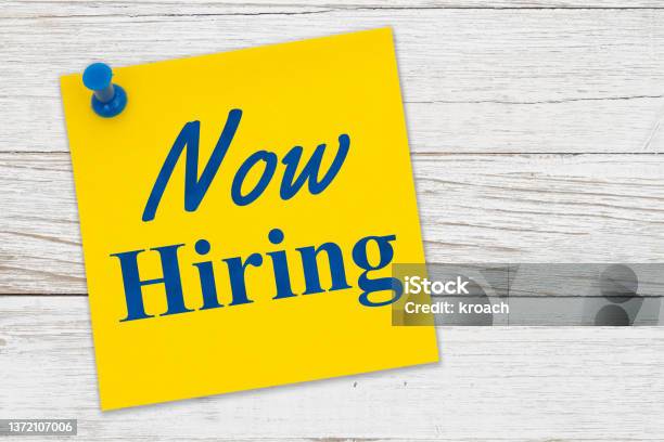 Now Hiring Message On A Yellow Sticky Note Paper With Pushpin Stock Photo - Download Image Now