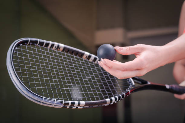 istock Image of a woman's hand with a squash racket. Sports concept 1372107151