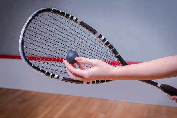 istock Image of a woman's hand with a squash racket. Sports concept 1372107152