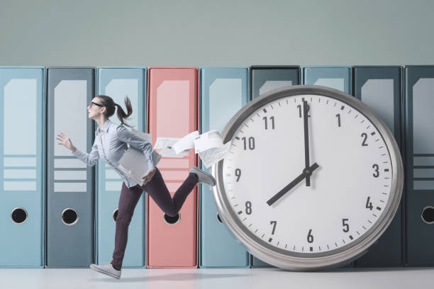 istock Businesswoman running fast and huge clock 1372107177