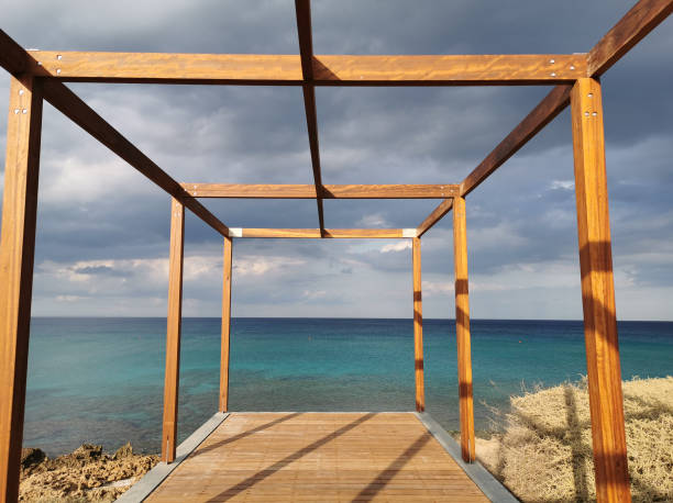 istock A timber-framed observation deck over the turquoise waters of the Mediterranean against a dramatic sky. 1372107312