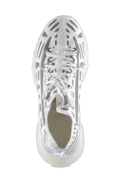 istock Sport shoes. White fabric trainers with gray reflective stripes. 1372107664
