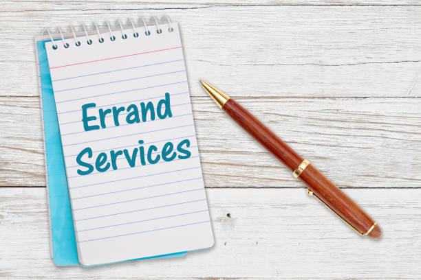 istock Errand Services message on retro lined paper notepad on a weathered wood desk 1372108474