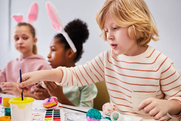 istock Little Kids Painting Easter Eggs 1372111472