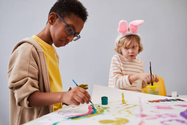 istock African-American Boy Painting in Art Class 1372111487