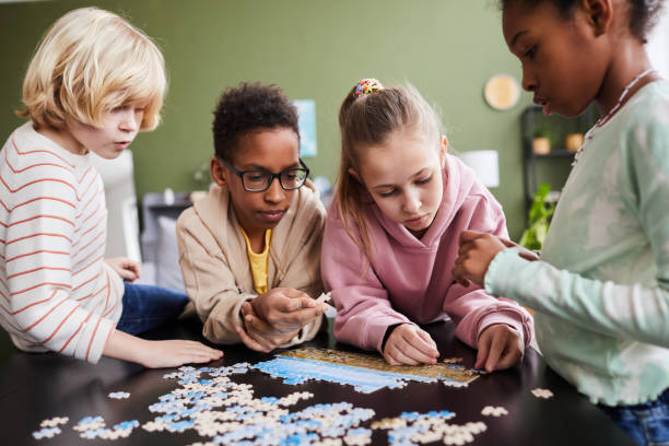 istock Group of Kids Playing with Jigsaw Puzzle 1372111516