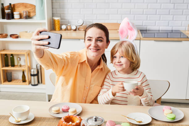 istock Mother and Son Taking Selfie in Morning 1372112336