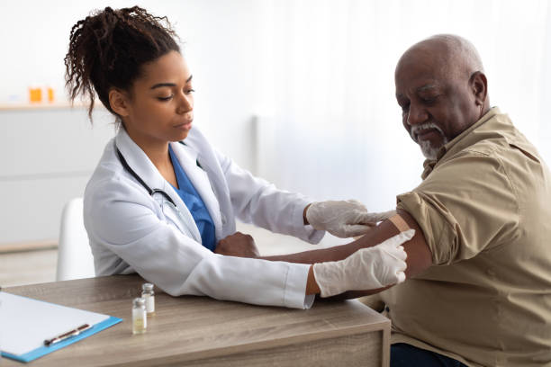 istock Senior Man Getting Vaccinated Against Covid, Doctor Applying Plaster 1372113543