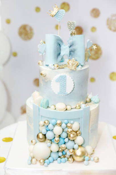 istock a light blue birthday cake decorated with a bow, hearts, crowns and balloons 1372113604