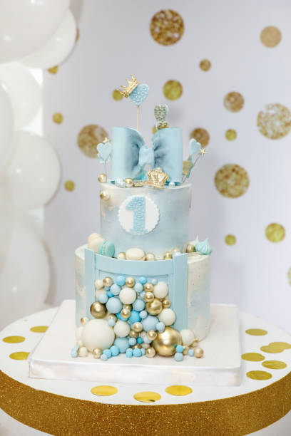 istock a light blue birthday cake decorated with a bow, hearts, crowns and balloons 1372113635