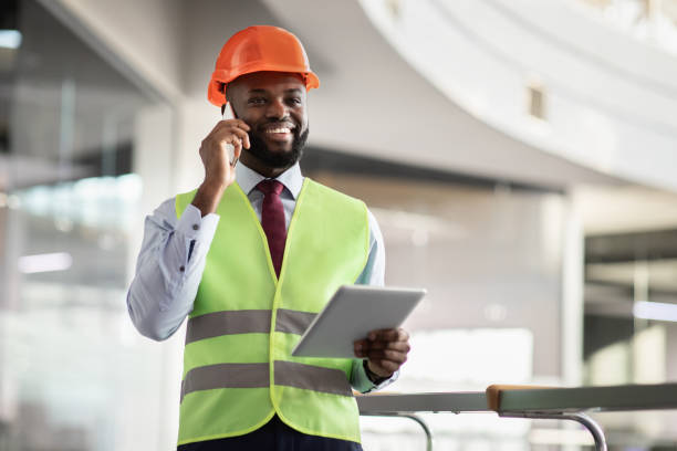 istock Happy african american architect having phone conversation, using digital tablet 1372113777