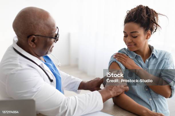 Pregnant Black Lady Getting Vaccinated Doctor Applying Adhesive Bandage Stock Photo - Download Image Now
