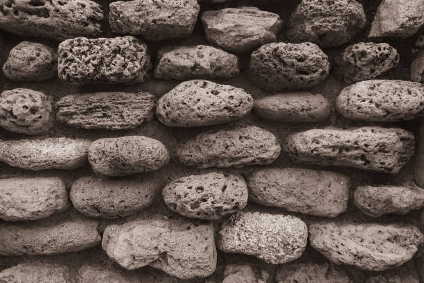 Round Stone Wall Sepia. Old Stone Wall Texture. Stone Wall Background Or Texture. Part Of Stone Wall. Background Or Texture. Oval Stones