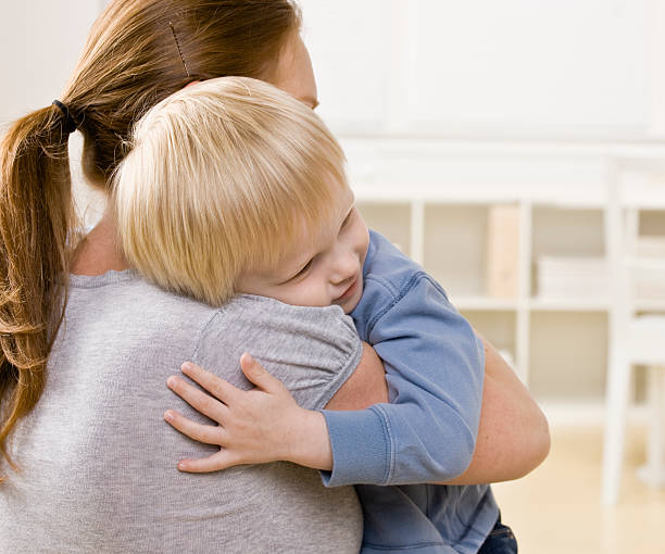 istock Devoted mother hugging and comforting her son 137211460