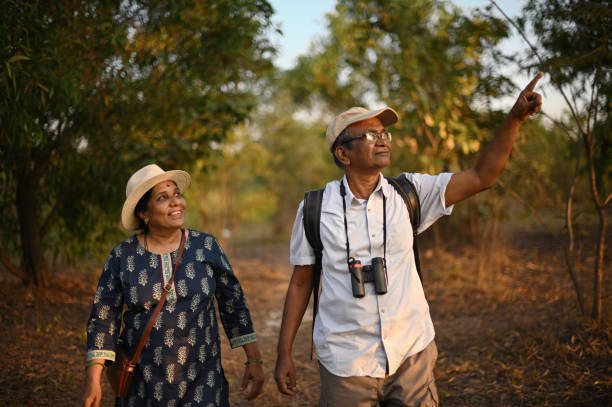 istock Old senior couple walking through a forest 1372115325