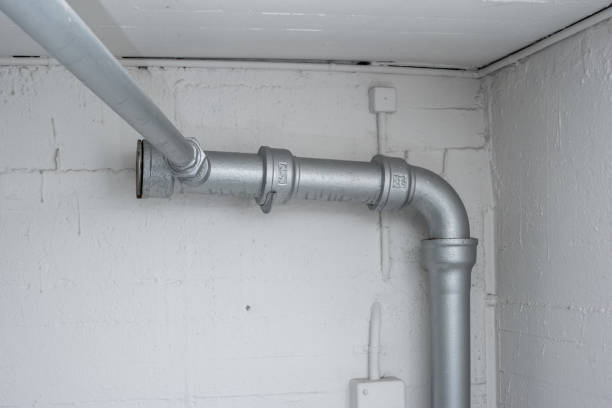 istock Thick plastic plumbing twisting tubes  inside communal laundry room inside apartment building. No people. 1372116679