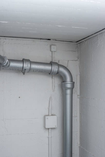istock Thick plastic plumbing twisting tubes  inside communal laundry room inside apartment building. No people. 1372116688