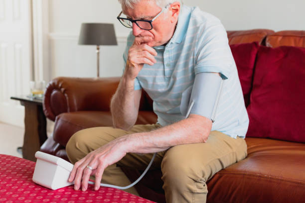 istock Senior man checking blood pressure using machine at home 1372117462