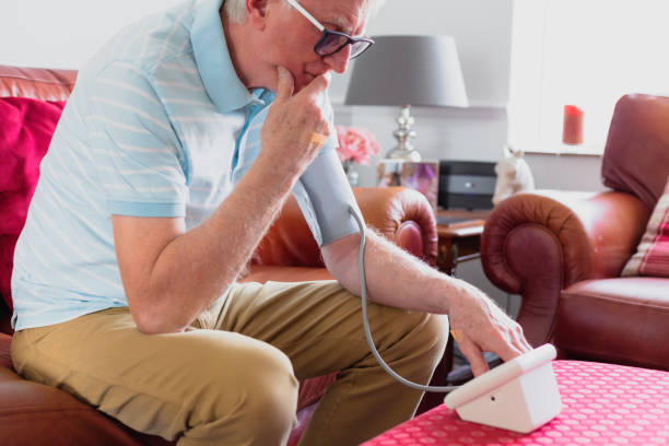 istock Senior man checking blood pressure using machine at home 1372117495