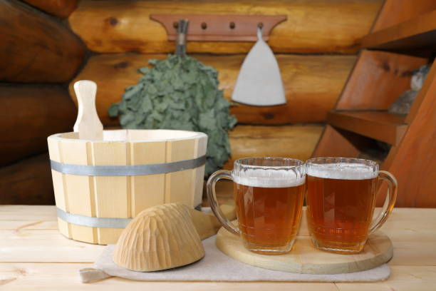 a couple mugs of light beer in sauna. - wooden hub imagens e fotografias de stock