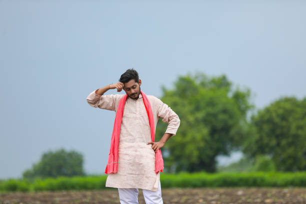 istock indian farmer standing at agriculture field. 1372119571