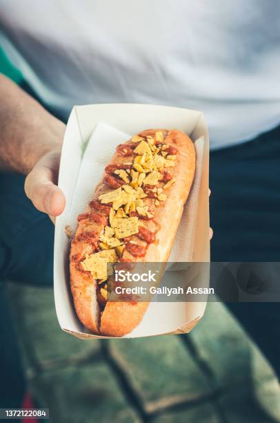 Freshly Prepared Hotdogs In A Paper Box In A Hand Food Delivery Concept Stock Photo - Download Image Now