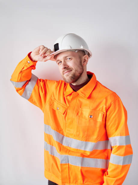 istock Construction site foreman portrait in orange vest and hard hat 1372123331