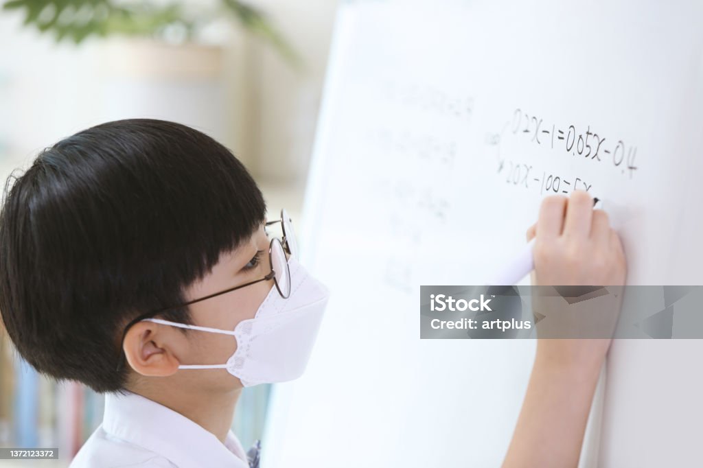 Boy Studying Hard And Solving Math Problems On The Blackboard Stock ...