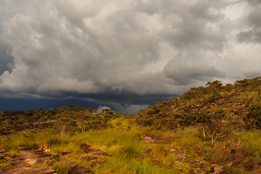 rocky mountains covered by the region's native vegetation, under a stormy sky with low clouds - SAO THOME DAS LETRAS, MG, BRAZIL.