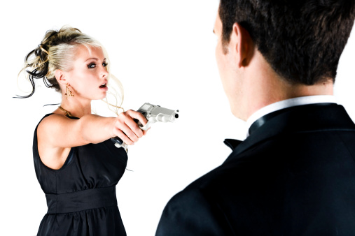 Young woman venturing to aim the gun at James Bond.