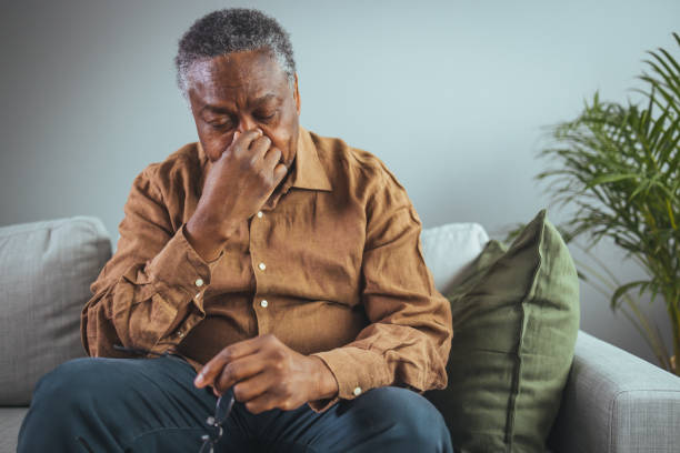 istock Thoughtful senior man sitting on couch. 1372123952