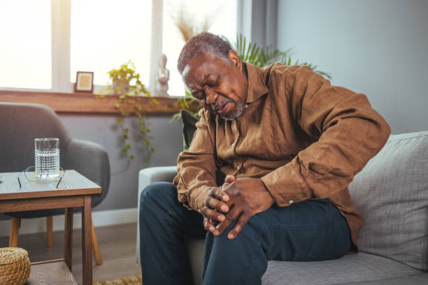 istock Senior man holds his hands up to his knees 1372124013