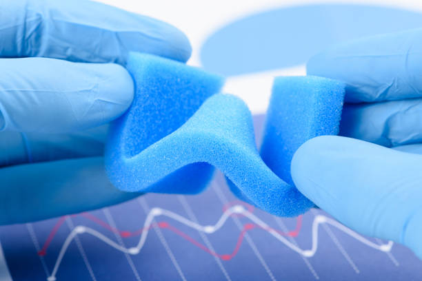 istock Blue porous foam material bended in scientist hands in laboratory. 1372124027