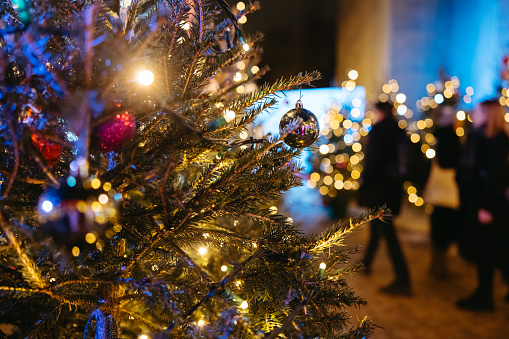Close up illuminated and decorated Christmas tree on street