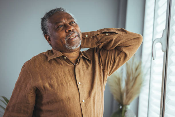 istock An older man suffers from back pain. 1372125702