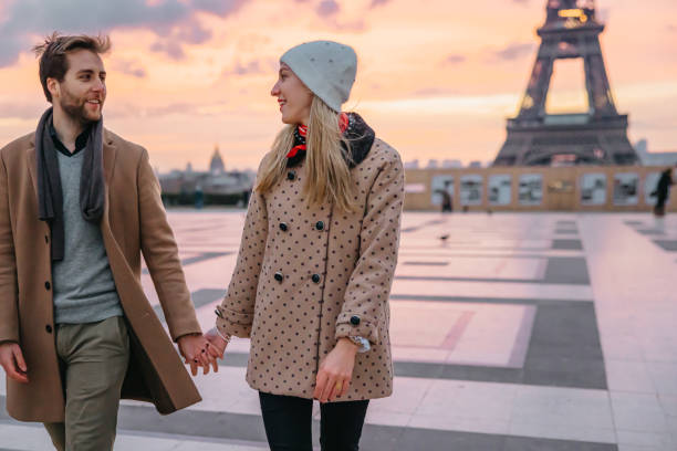 istock Romantic couple holding hands and look at each other while walking on Parvis des Droits de l'Homme, Paris 1372127200