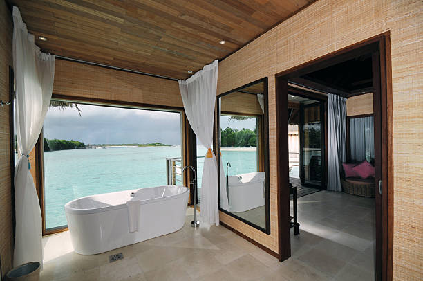 Luxury vacation suite with a sunny water view Luxury Room  maldivian culture stock pictures, royalty-free photos & images