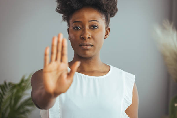 istock Serious african american woman protesting against bullying. 1372127966