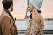 Close-up of couple, man looking at Eiffel Tower, girlfriend looking at her boyfriend, Paris