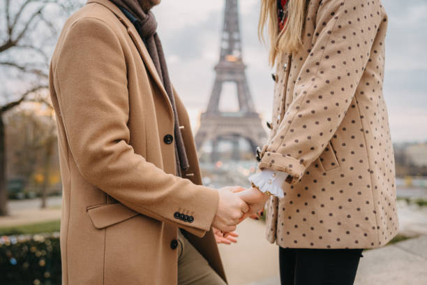 istock Close-Up, couple holding hands in front of Eiffel Tower, Paris 1372128272