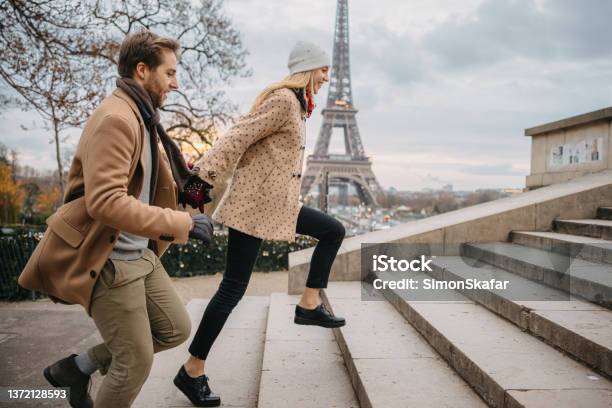 Young Couple Running Up Stairs To Parvis Des Droits De Lhomme Paris In Front Of Eiffel Tower Stock Photo - Download Image Now