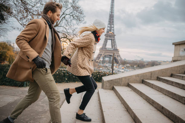 istock Couple running up stairs to a observation platform in front of Eiffel Tower Paris 1372128652