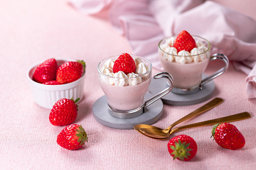 Strawberry mousse with whipped cream and fresh strawberries in a glasses